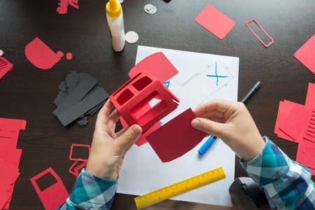 designer working with paper modeling craft template