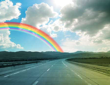 Storm weather and rainbow on road, travel concept