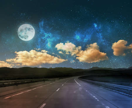 night road background with moon and starsの写真素材