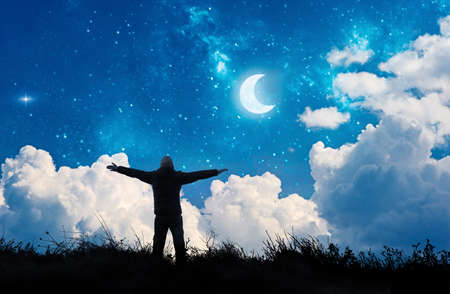alone man watching the stars and moon in night sky