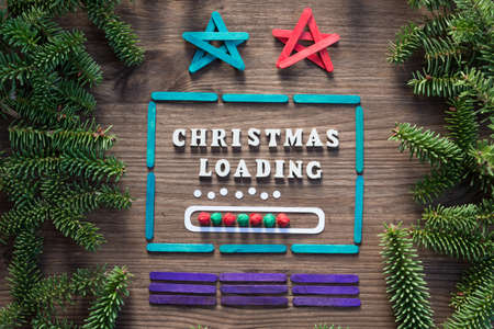 colorful christmas laptop with loading bar concept on wooden background