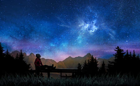 Girl watching the stars and nebula in night skyの写真素材