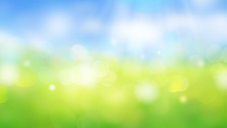 Blurred sky and green field abstract background with sun raysの写真素材