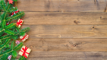 Christmas fir tree on a wooden background with presentsの写真素材