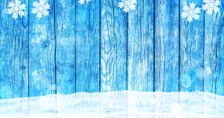 Christmas background with blue wooden board and snowの写真素材