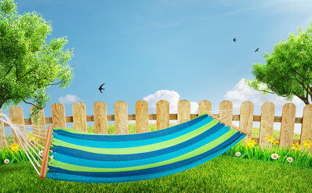 relaxing on hammock in backyard in spring flowers and grass gardenの写真素材