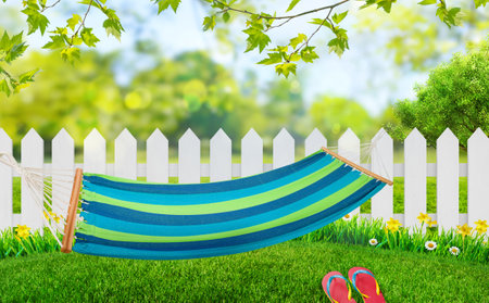 relaxing on hammock in backyard in spring flowers and grass gardenの写真素材