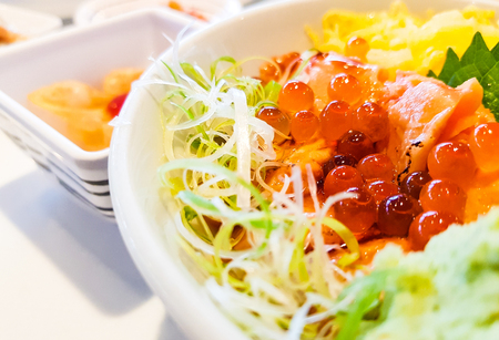 Rice with Salmon Sashimi and Salmon egg on white plate.の写真素材
