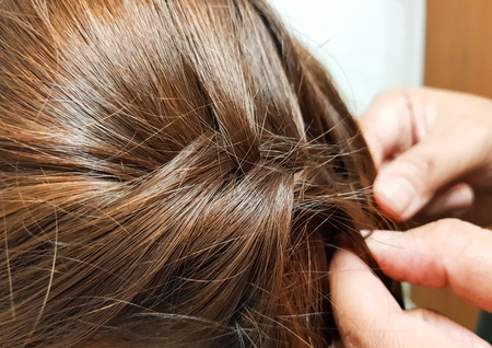 Close-up pigtail hairstyle,hand stylist.の写真素材