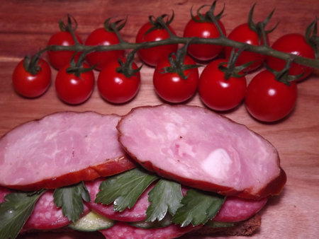 sandwich with different types of sausage and vegetables, quick snack. High quality photo