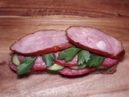 sandwich with different types of sausage and vegetables, quick snack. High quality photo