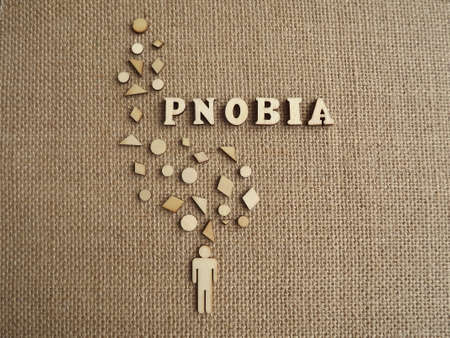mental illness-phobia in the form of wooden letters and figures of people on a jute background. High quality photoの写真素材