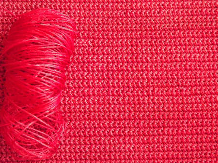 knitted fabric in red color as a background. High quality photo