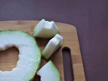 ripe melon cut into slices on a wooden board. High quality photo