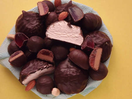 chocolate candies, marshmallows, marmalade and various nuts close-up. High quality photo