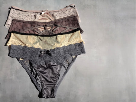 A set of 4 womens panties of different colors on a gray background in the form of a layout. High quality photoの写真素材
