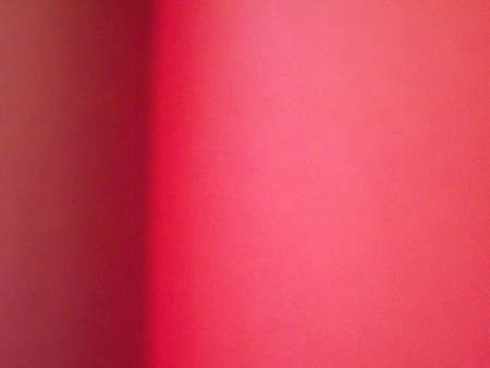 Burgundy, crimson, red, pink paper surface with a clear separation of colors as a background. High...