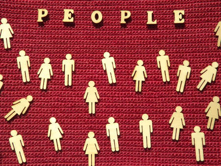 Wooden figures of men and women on a cork tree background. High quality photoの写真素材