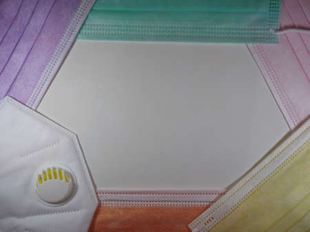 Background frame with medical attributes face masks and respirators of different colors. High quality photoの写真素材