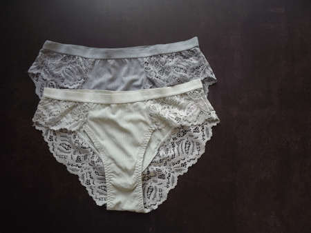 A pair of womens guipure panties on a black background. High quality photoの写真素材