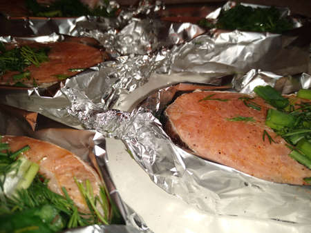 The process of cooking red trout fish with greens in foil. High quality photoの写真素材