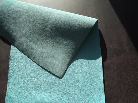 Genuine leather and genuine suede turquoise blue close-up as background. high quality photoの写真素材