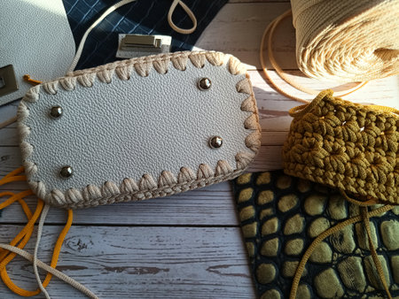 The process of crocheting a handbag made of cord and leather accessories. High quality photo