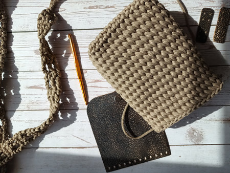 The process of crocheting a handbag made of cord and leather accessories. High quality photoの写真素材