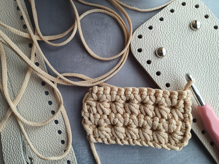 The process of crocheting a handbag made of cord and leather accessories. High quality photoの写真素材