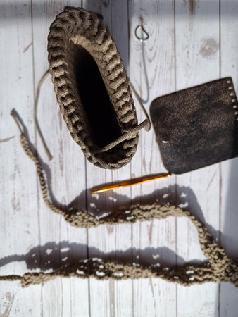 The process of crocheting a handbag made of cord and leather accessories. High quality photo
