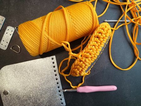The process of crocheting a handbag made of cord and leather accessories. High quality photo