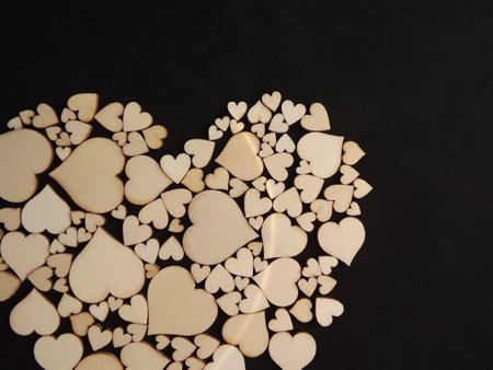 Wooden hearts on a black background as a postcard for the holidays. High quality photoの写真素材