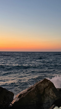 Sunset on the Mediterranean Sea in Tarragona, Catalonia, Spainの写真素材