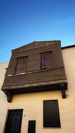Old wooden window with shutters on the facade of the building.の写真素材