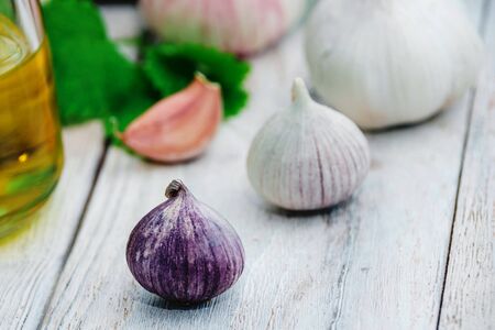 fresh ripe garlic on wooden table, vegetable salad ingredientsの写真素材