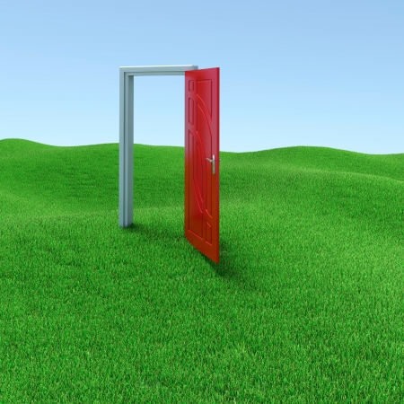 Green lawn with mysterious door opened to another realityの写真素材
