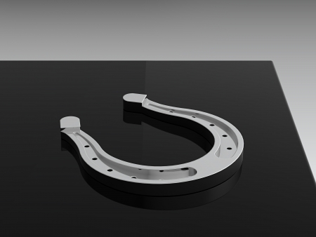 3D render of silver horseshoe on black tableの写真素材