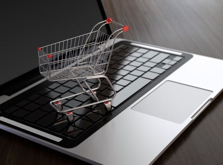 Computer generated image of shopping cart on laptop. E-commerce concept.の写真素材