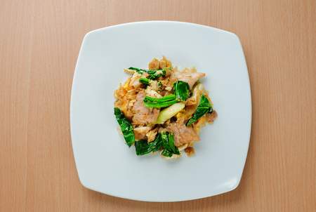 Stir fried flat noodle and pork with dark soy sauce (Thai people called Pad See Ew)の写真素材