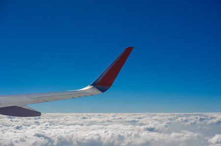 Aerial view of airplane flying above shade clouds and sky from an airplane fly. View from the plane...
