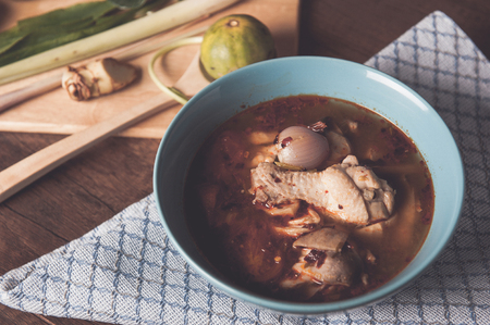 Hot and spicy chicken soup in bowl on wooden background Thai food Tom Yum Chicken Tom Yum is thai delicious food.の写真素材