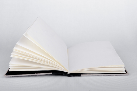 White opened book with blank pages white backgroundの写真素材