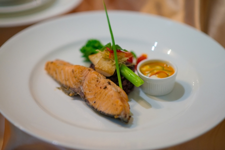 Salmon steak in red curry cream sauce selective focusの写真素材