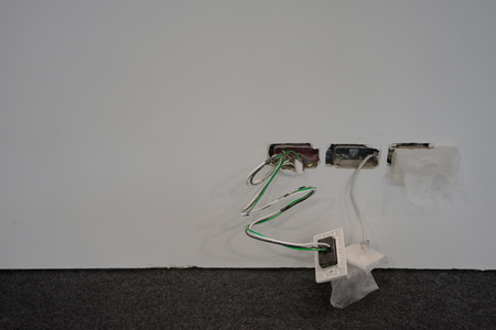 Exposed wire in the electrical wiring in the wall copy space