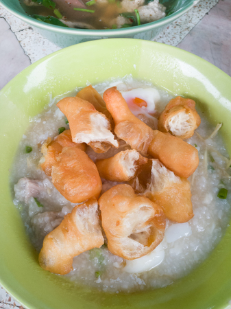 Rice porridge rice gruel congee rice soup with egg and porkの写真素材