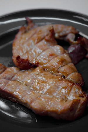 pork steak grilled with salad and tomato and Shallow depth of fieldの写真素材