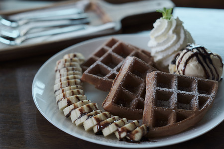 Homemade Belgian waffles with with bananas and ice cream.