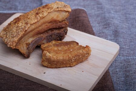 Thai crispy skin pork belly on wooden board, copy spaceの写真素材