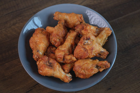 Delicious fresh crispy chicken on a dark wood background. Unhealthy food, fast foodの写真素材