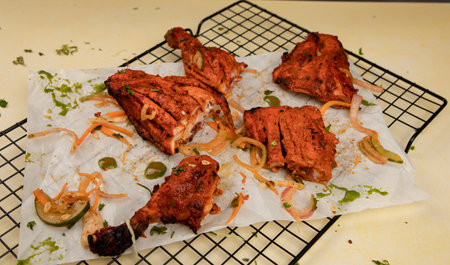 TANDOORI CHICKEN:
Juicy and well marinated chicken slow cooked in tandoor and served with accompaniments.の写真素材